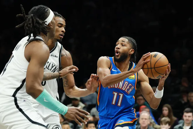 NEW YORK, NEW YORK - MARCH 18: Isaiah Joe #11 of the Oklahoma City Thunder looks to pass as Nic Claxton #33 of the Brooklyn Nets defends during the first half at Barclays Center on March 18, 2026 in the Brooklyn borough of New York City. NOTE TO USER: User expressly acknowledges and agrees that, by downloading and or using this photograph, User is consenting to the terms and conditions of the Getty Images License Agreement. (Photo by Sarah Stier/Getty Images)