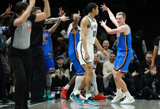 NEW YORK, NEW YORK - MARCH 18: Payton Sandfort #14 of the Oklahoma City Thunder reacts with the bench after scoring in his NBA debut during the second half against the Brooklyn Nets at Barclays Center on March 18, 2026 in the Brooklyn borough of New York City. The Thunder won 121-92. NOTE TO USER: User expressly acknowledges and agrees that, by downloading and or using this photograph, User is consenting to the terms and conditions of the Getty Images License Agreement. (Photo by Sarah Stier/Getty Images)