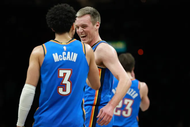 NEW YORK, NEW YORK - MARCH 18: Payton Sandfort #14 reacts with Jared McCain #3 of the Oklahoma City Thunder after scoring in his NBA debut during the second half against the Brooklyn Nets at Barclays Center on March 18, 2026 in the Brooklyn borough of New York City. The Thunder won 121-92. NOTE TO USER: User expressly acknowledges and agrees that, by downloading and or using this photograph, User is consenting to the terms and conditions of the Getty Images License Agreement. (Photo by Sarah Stier/Getty Images)