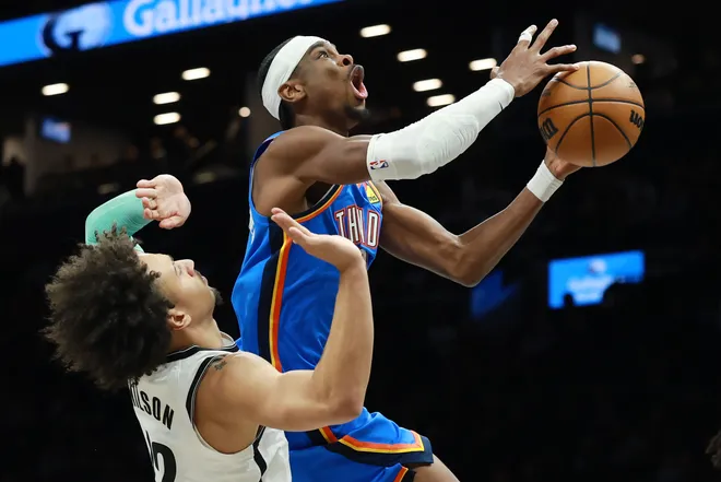 NEW YORK, NEW YORK - MARCH 18: Shai Gilgeous-Alexander #2 of the Oklahoma City Thunder goes to the basket as Jalen Wilson #22 of the Brooklyn Nets defends during the first half at Barclays Center on March 18, 2026 in the Brooklyn borough of New York City. NOTE TO USER: User expressly acknowledges and agrees that, by downloading and or using this photograph, User is consenting to the terms and conditions of the Getty Images License Agreement. (Photo by Sarah Stier/Getty Images)