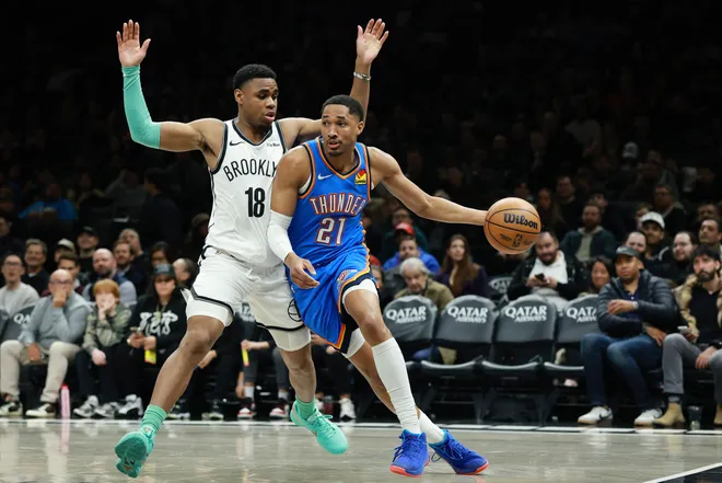 NEW YORK, NEW YORK - MARCH 18: Aaron Wiggins #21 of the Oklahoma City Thunder dribbles against Malachi Smith #18 of the Brooklyn Nets during the first half at Barclays Center on March 18, 2026 in the Brooklyn borough of New York City. NOTE TO USER: User expressly acknowledges and agrees that, by downloading and or using this photograph, User is consenting to the terms and conditions of the Getty Images License Agreement. (Photo by Sarah Stier/Getty Images)