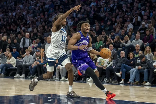 Mar 18, 2026; Minneapolis, Minnesota, USA; Utah Jazz guard Isaiah Collier (8) drives to the basket past Minnesota Timberwolves guard Ayo Dosunmu (13) in the second half at Target Center.