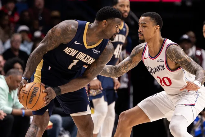 Mar 18, 2026; New Orleans, Louisiana, USA; New Orleans Pelicans forward Zion Williamson (1) dribbles against LA Clippers forward/center John Collins (20) during second half at Smoothie King Center.