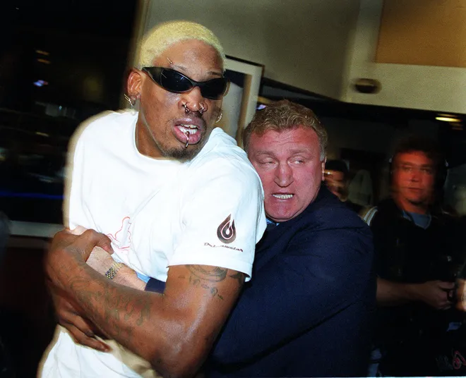 Dennis Rodman of WCW and NBA Star is held back by former Australian Boxing champion Joe Bugner.