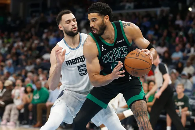 Mar 20, 2026; Memphis, Tennessee, USA; Boston Celtics forward Jayson Tatum (0) handles the ball as Memphis Grizzlies forward Tyler Burton (5) defends during the third quarter at FedExForum. Mandatory Credit: Petre Thomas-Imagn Images