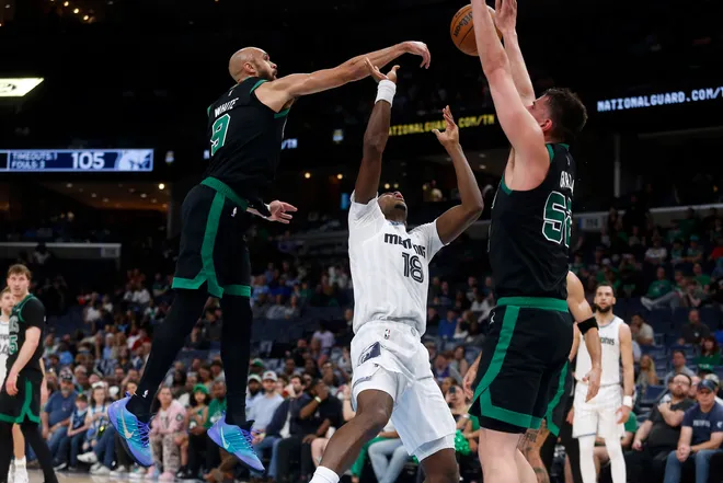 Mar 20, 2026; Memphis, Tennessee, USA; Boston Celtics guard Derrick White (9) blocks a shot attempt by Memphis Grizzlies forward Olivier-Maxence Prosper (18) during the fourth quarter at FedExForum. Mandatory Credit: Petre Thomas-Imagn Images