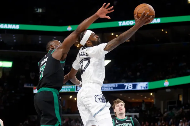 Mar 20, 2026; Memphis, Tennessee, USA; Memphis Grizzlies guard DeJon Jarreau (77) shoots as Boston Celtics guard Jaylen Brown (7) defends during the third quarter at FedExForum. Mandatory Credit: Petre Thomas-Imagn Images