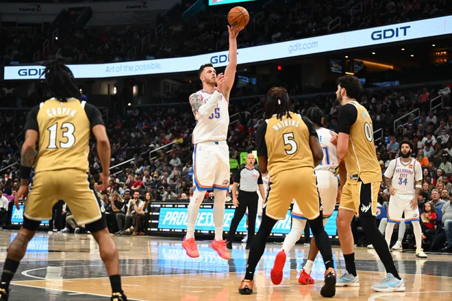 Mar 21, 2026; Washington, District of Columbia, USA; Oklahoma City Thunder center/forward Isaiah Hartenstein (55) passes the ball over Washington Wizards forward Jamir Watkins (5) and forward Tristan Vukcevic (00) during the second half at Capital One Arena. Mandatory Credit: Brad Mills-Imagn Images
