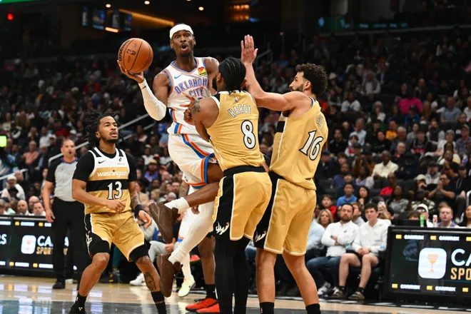 Mar 21, 2026; Washington, District of Columbia, USA; Oklahoma City Thunder guard Shai Gilgeous-Alexander (2) passes the ball past Washington Wizards guard Jaden Hardy (8) and forward Anthony Gill (16) during the second half at Capital One Arena. Mandatory Credit: Brad Mills-Imagn Images