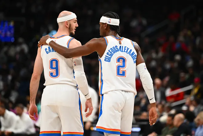 Mar 21, 2026; Washington, District of Columbia, USA; Oklahoma City Thunder guard Shai Gilgeous-Alexander (2) talks with guard Alex Caruso (9) against the Washington Wizards during the first half at Capital One Arena. Mandatory Credit: Brad Mills-Imagn Images