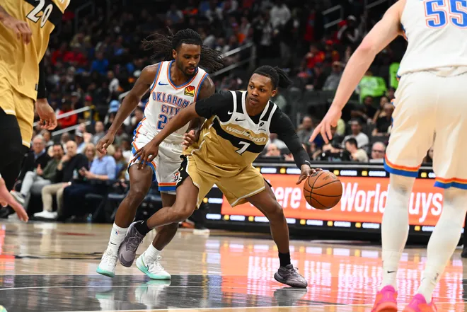 Mar 21, 2026; Washington, District of Columbia, USA; Washington Wizards guard Bub Carrington (7) dribbles as Oklahoma City Thunder guard Cason Wallace (22) defends during the first half at Capital One Arena. Mandatory Credit: Brad Mills-Imagn Images