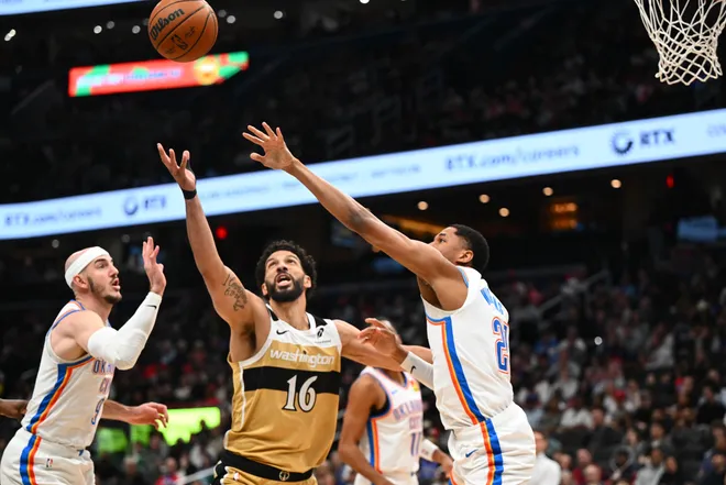Mar 21, 2026; Washington, District of Columbia, USA; Washington Wizards forward Anthony Gill (16) reaches for a rebound against Oklahoma City Thunder guard Aaron Wiggins (21) during the first half at Capital One Arena. Mandatory Credit: Brad Mills-Imagn Images