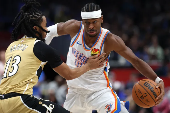 WASHINGTON, DC - MARCH 21: Shai Gilgeous-Alexander #2 of the Oklahoma City Thunder dribbles past Sharife Cooper #13 of the Washington Wizards during the first half at Capital One Arena on March 21, 2026 in Washington, DC. NOTE TO USER: User expressly acknowledges and agrees that, by downloading and or using this photograph, User is consenting to the terms and conditions of the Getty Images License Agreement. (Photo by Patrick Smith/Getty Images)