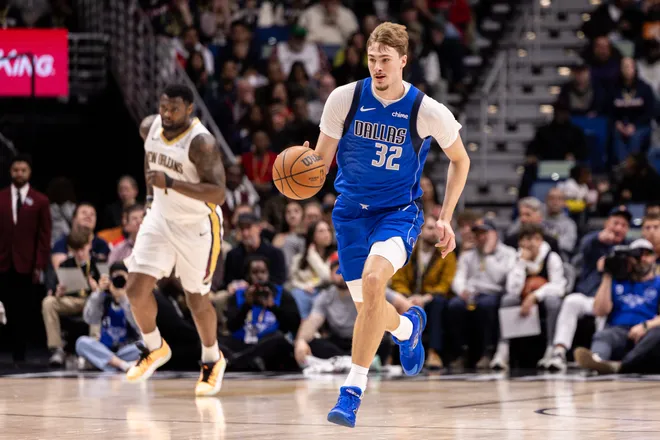 Mar 16, 2026; New Orleans, Louisiana, USA; Dallas Mavericks forward Cooper Flagg (32) brings the ball up court against New Orleans Pelicans forward Zion Williamson (1) during the first half at Smoothie King Center. Mandatory Credit: Stephen Lew-Imagn Images