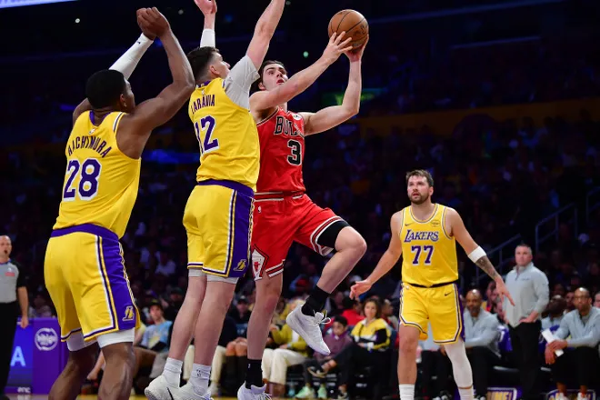 Mar 12, 2026; Los Angeles, California, USA; Chicago Bulls guard Josh Giddey (3) moves to the basket against Los Angeles Lakers forward Jake LaRavia (12) and forward Rui Hachimura (28) during the second half at Crypto.com Arena. Mandatory Credit: Gary A. Vasquez-Imagn Images