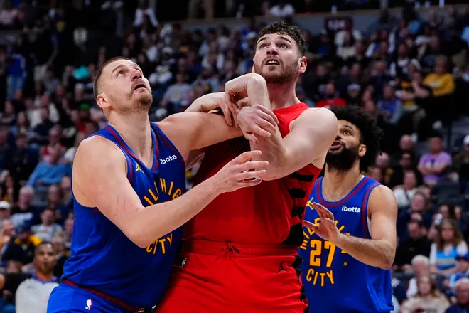 Mar 22, 2026; Denver, Colorado, USA; Portland Trail Blazers center Donovan Clingan (23) and Denver Nuggets center Nikola Jokic (15) fight for position during the second half at Ball Arena. Mandatory Credit: Ron Chenoy-Imagn Images