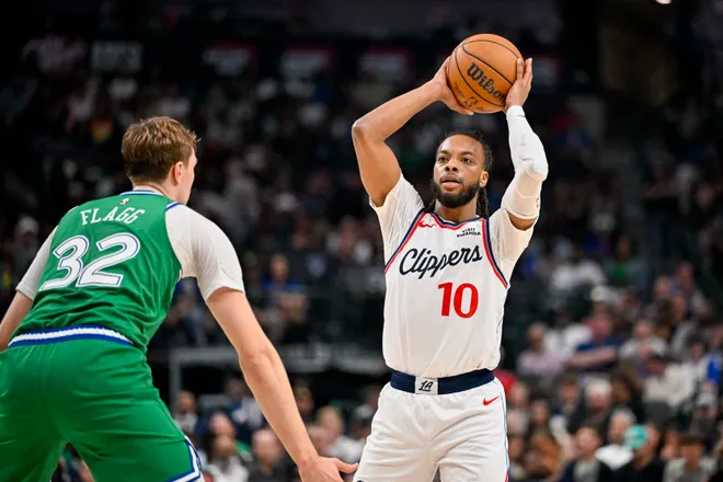 Mar 21, 2026; Dallas, Texas, USA; LA Clippers guard Darius Garland (10) looks to pass the ball over Dallas Mavericks forward Cooper Flagg (32) during the second quarter at the American Airlines Center. Mandatory Credit: Jerome Miron-Imagn Images