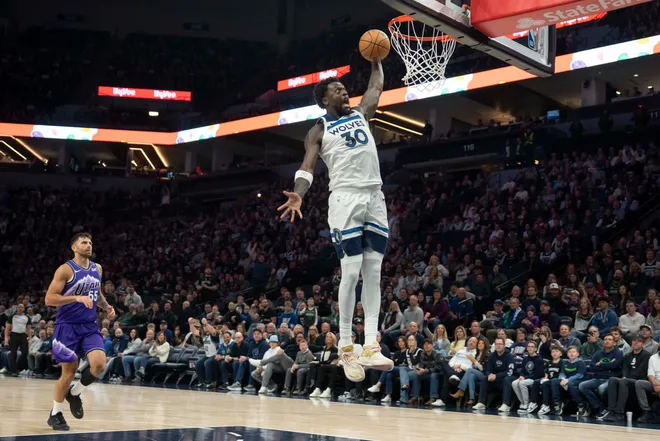 Mar 18, 2026; Minneapolis, Minnesota, USA; Minnesota Timberwolves forward Julius Randle (30) dunks the ball in front of Utah Jazz guard John Konchar (55) in the first half at Target Center. Mandatory Credit: Jesse Johnson-Imagn Images