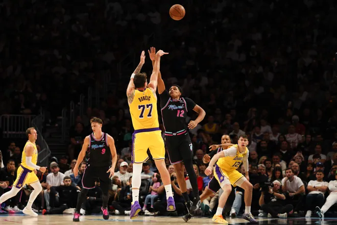Mar 19, 2026; Miami, Florida, USA; Los Angeles Lakers guard Luka Doncic (77) shoots over Miami Heat guard Dru Smith (12) during the second half at Kaseya Center. Mandatory Credit: Isabella Frias-Imagn Images