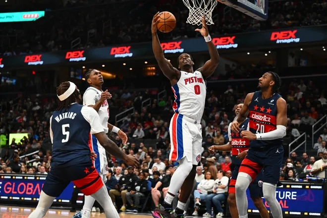 Mar 19, 2026; Washington, District of Columbia, USA; Detroit Pistons center Jalen Duren (0) grabs a rebound over Washington Wizards guard Jamir Watkins (5) and center Alex Sarr (20) during the first half at Capital One Arena. Mandatory Credit: Brad Mills-Imagn Images