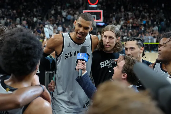 Mar 19, 2026; San Antonio, Texas, USA; San Antonio Spurs forward Victor Wembanyama (1) gives an interview beside forward Kelly Olynyk (8) after the game against the Phoenix Suns at Frost Bank Center. Mandatory Credit: Daniel Dunn-Imagn Images
