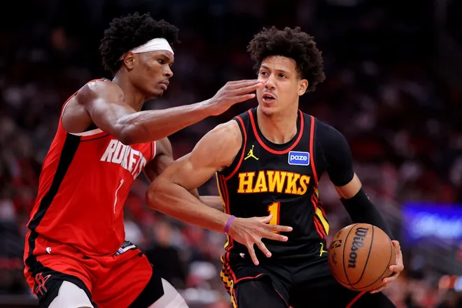 Mar 20, 2026; Houston, Texas, USA; Atlanta Hawks forward Jalen Johnson (1) drives to the basket against Houston Rockets guard Amen Thompson (1) during the fourth quarter at Toyota Center.