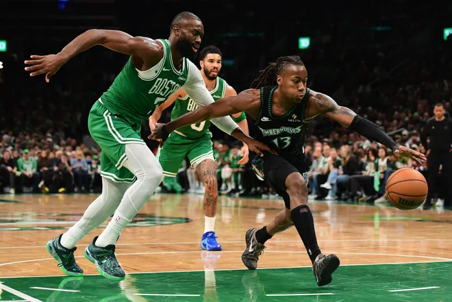 Mar 22, 2026; Boston, Massachusetts, USA; Minnesota Timberwolves guard Ayo Dosunmu (13) reaches for the ball while Boston Celtics guard Jaylen Brown (7) defends during the second half at TD Garden. Mandatory Credit: Bob DeChiara-Imagn Images