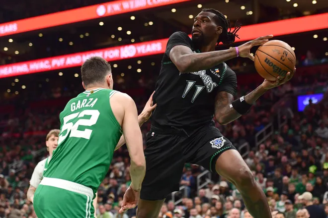 Mar 22, 2026; Boston, Massachusetts, USA; Minnesota Timberwolves center Naz Reid (11) looks to pass the ball while Boston Celtics center Luka Garza (52) defends during the second half at TD Garden. Mandatory Credit: Bob DeChiara-Imagn Images