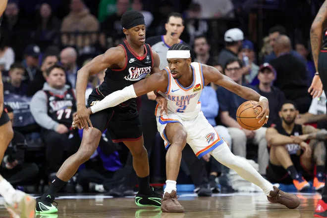 Mar 23, 2026; Philadelphia, Pennsylvania, USA; Oklahoma City Thunder guard Shai Gilgeous-Alexander (2) controls the ball agains Philadelphia 76ers guard Vj Edgecombe (77) during the first quarter at Xfinity Mobile Arena. Mandatory Credit: Bill Streicher-Imagn Images