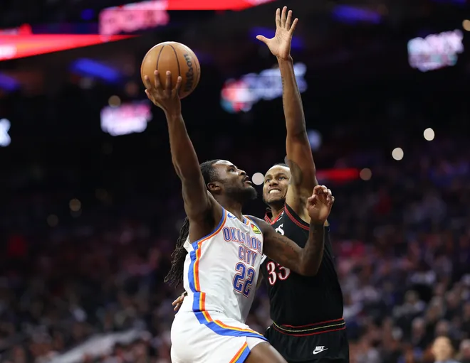 Mar 23, 2026; Philadelphia, Pennsylvania, USA; Oklahoma City Thunder guard Cason Wallace (22) drives against Philadelphia 76ers forward Jabari Walker (33) during the third quarter at Xfinity Mobile Arena. Mandatory Credit: Bill Streicher-Imagn Images