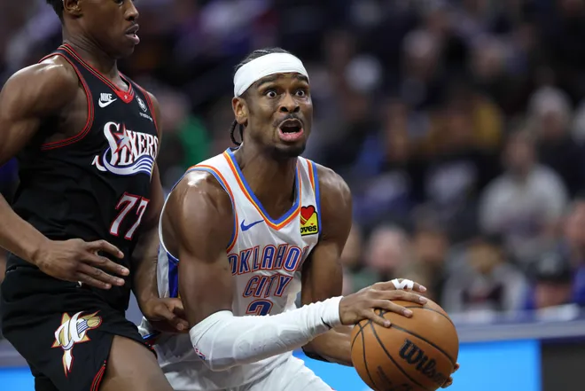 Mar 23, 2026; Philadelphia, Pennsylvania, USA; Oklahoma City Thunder guard Shai Gilgeous-Alexander (2) drives past Philadelphia 76ers guard Vj Edgecombe (77) during the third quarter at Xfinity Mobile Arena. Mandatory Credit: Bill Streicher-Imagn Images