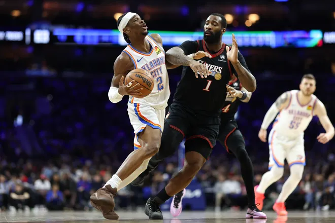Mar 23, 2026; Philadelphia, Pennsylvania, USA; Oklahoma City Thunder guard Shai Gilgeous-Alexander (2) drives against Philadelphia 76ers center Andre Drummond (1) during the third quarter at Xfinity Mobile Arena. Mandatory Credit: Bill Streicher-Imagn Images