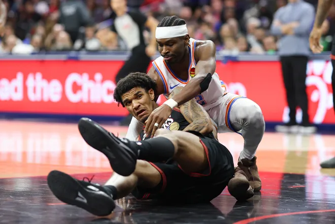 Mar 23, 2026; Philadelphia, Pennsylvania, USA; Oklahoma City Thunder guard Shai Gilgeous-Alexander (2) and Philadelphia 76ers forward Dominick Barlow (25) battle for a loose ball during the third quarter at Xfinity Mobile Arena. Mandatory Credit: Bill Streicher-Imagn Images