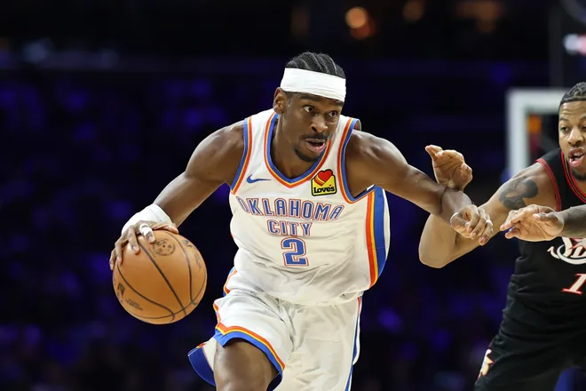 Mar 23, 2026; Philadelphia, Pennsylvania, USA; Oklahoma City Thunder guard Shai Gilgeous-Alexander (2) drives past Philadelphia 76ers forward Dalen Terry (14) during the third quarter at Xfinity Mobile Arena. Mandatory Credit: Bill Streicher-Imagn Images