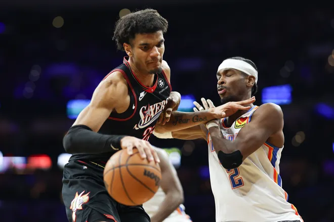 Mar 23, 2026; Philadelphia, Pennsylvania, USA; Philadelphia 76ers forward Dominick Barlow (25) controls the ball against Oklahoma City Thunder guard Shai Gilgeous-Alexander (2) during the second quarter at Xfinity Mobile Arena. Mandatory Credit: Bill Streicher-Imagn Images