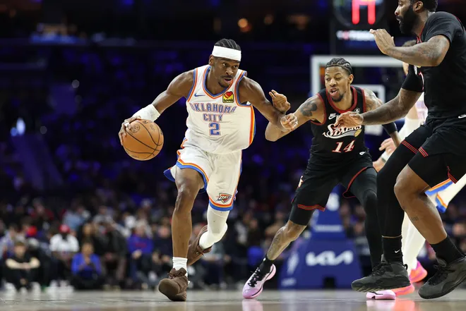 Mar 23, 2026; Philadelphia, Pennsylvania, USA; Oklahoma City Thunder guard Shai Gilgeous-Alexander (2) drives past Philadelphia 76ers forward Dalen Terry (14) during the third quarter at Xfinity Mobile Arena. Mandatory Credit: Bill Streicher-Imagn Images