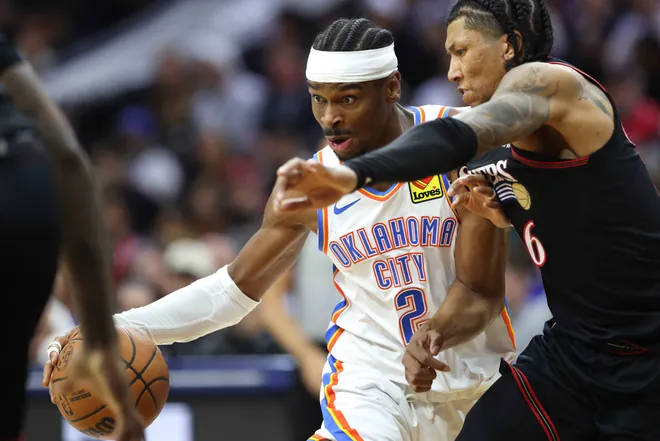Mar 23, 2026; Philadelphia, Pennsylvania, USA; Oklahoma City Thunder guard Shai Gilgeous-Alexander (2) drives against Philadelphia 76ers forward Marjon Beauchamp (16) during the third quarter at Xfinity Mobile Arena. Mandatory Credit: Bill Streicher-Imagn Images