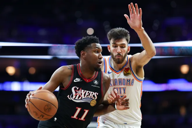 Mar 23, 2026; Philadelphia, Pennsylvania, USA; Philadelphia 76ers forward Justin Edwards (11) drives against Oklahoma City Thunder center Chet Holmgren (7) during the first quarter at Xfinity Mobile Arena. Mandatory Credit: Bill Streicher-Imagn Images