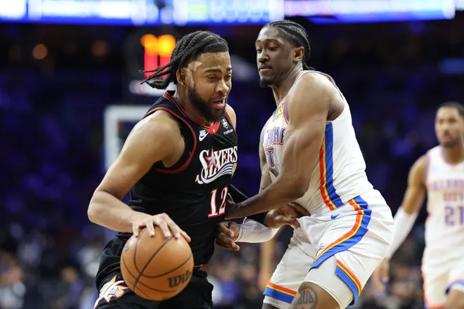 Mar 23, 2026; Philadelphia, Pennsylvania, USA; Philadelphia 76ers forward Trendon Watford (12) drives agains Oklahoma City Thunder guard Jalen Williams (8 during the second quarter at Xfinity Mobile Arena. Mandatory Credit: Bill Streicher-Imagn Images