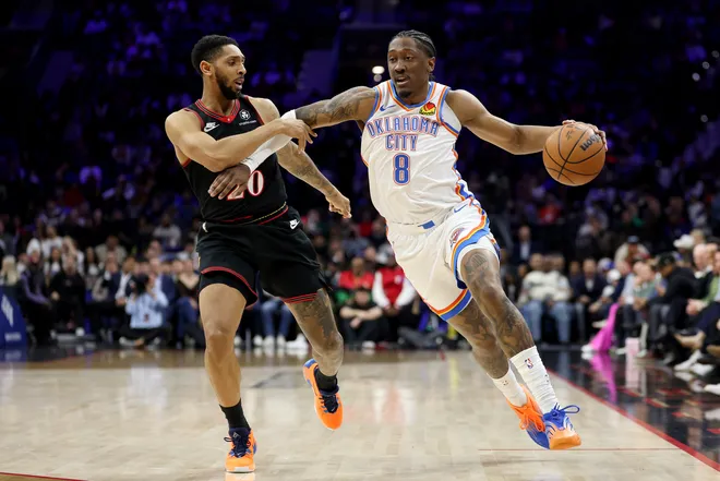 PHILADELPHIA, PENNSYLVANIA - MARCH 23: Jalen Williams #8 of the Oklahoma City Thunder drives past Cameron Payne #20 of the Philadelphia 76ers during the first half at Xfinity Mobile Arena on March 23, 2026 in Philadelphia, Pennsylvania. NOTE TO USER: User expressly acknowledges and agrees that, by downloading and or using this photograph, User is consenting to the terms and conditions of the Getty Images License Agreement. (Photo by Emilee Chinn/Getty Images)