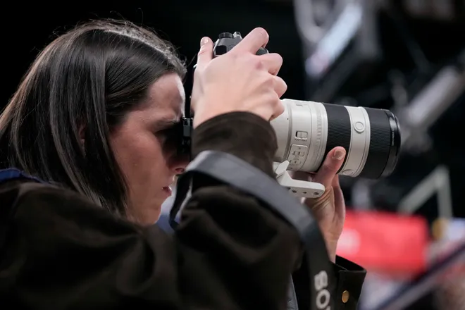 Indiana Fever guard Caitlin Clark takes photographs Wednesday, March 25, 2026, during a game against the Los Angeles Lakers at Gainbridge Fieldhouse in Indianapolis.