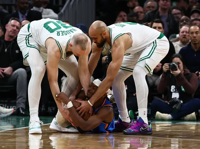 Mar 25, 2026; Boston, Massachusetts, USA; Boston Celtics forward Sam Hauser (30) and guard Derrick White (9) try to tie up Oklahoma City Thunder guard Shai Gilgeous-Alexander (2) during the fourth quarter at TD Garden. Mandatory Credit: Winslow Townson-Imagn Images