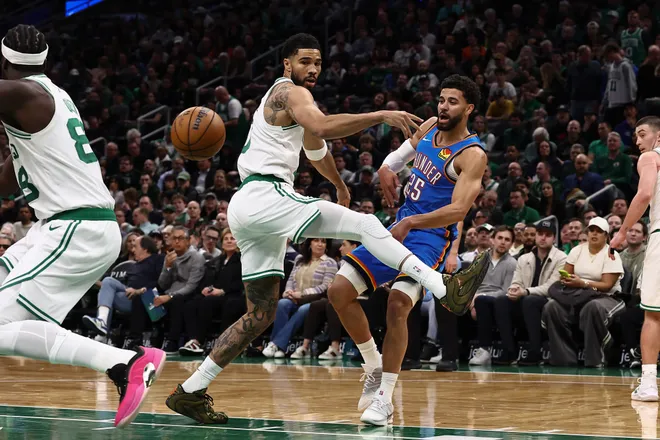 Mar 25, 2026; Boston, Massachusetts, USA; Oklahoma City Thunder guard Ajay Mitchell (25) passes past Boston Celtics forward Jayson Tatum (0) during the second quarter at TD Garden. Mandatory Credit: Winslow Townson-Imagn Images