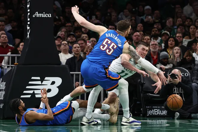 Mar 25, 2026; Boston, Massachusetts, USA; Boston Celtics guard Payton Pritchard (11) passes the ball past Oklahoma City Thunder center Isaiah Hartenstein (55) during the second quarter at TD Garden. Mandatory Credit: Winslow Townson-Imagn Images
