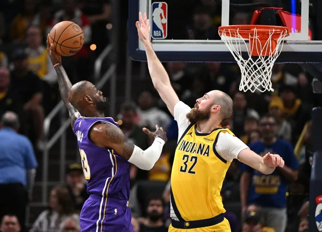 Mar 25, 2026; Indianapolis, Indiana, USA; Los Angeles Lakers forward LeBron James (23) dunks the ball past Indiana Pacers center Jay Huff (32) during the second quarter at Gainbridge Fieldhouse.
