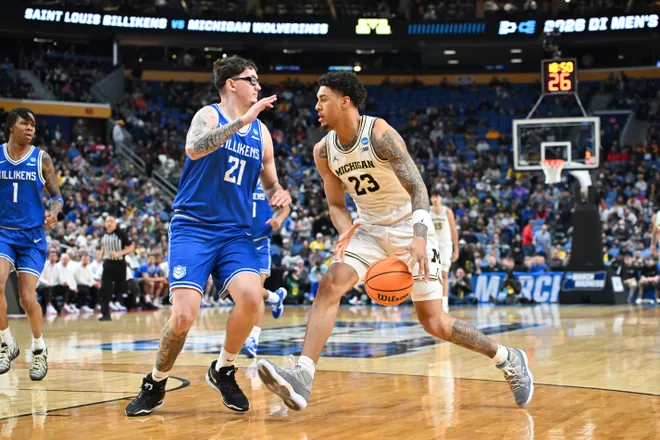 Mar 21, 2026; Buffalo, NY, USA; Michigan Wolverines forward Yaxel Lendeborg (23) drives the ball while defended by Saint Louis Billikens center Robbie Avila (21) in the second half during a second round game of the men's 2026 NCAA Tournament at Keybank Center. Mandatory Credit: Mark Konezny-Imagn Images