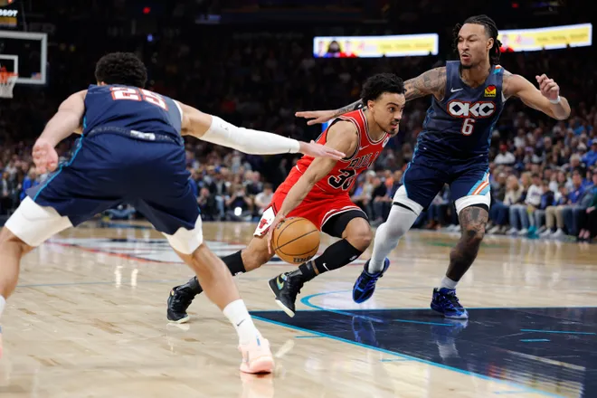 Mar 27, 2026; Oklahoma City, Oklahoma, USA; Chicago Bulls guard Tre Jones (30) drives between Oklahoma City Thunder guard Ajay Mitchell (25) and forward Jaylin Williams (6) during the second half at Paycom Center. Mandatory Credit: Alonzo Adams-Imagn Images