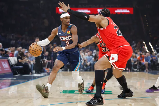 Mar 27, 2026; Oklahoma City, Oklahoma, USA; Oklahoma City Thunder guard Shai Gilgeous-Alexander (2) drives around Chicago Bulls forward Isaac Okoro (35) and forward Guerschon Yabusele (28) during the first quarter at Paycom Center. Mandatory Credit: Alonzo Adams-Imagn Images