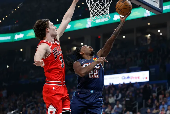Mar 27, 2026; Oklahoma City, Oklahoma, USA; Oklahoma City Thunder guard Cason Wallace (22) goes up for a basket beside Chicago Bulls guard Josh Giddey (3) during the first quarter at Paycom Center. Mandatory Credit: Alonzo Adams-Imagn Images