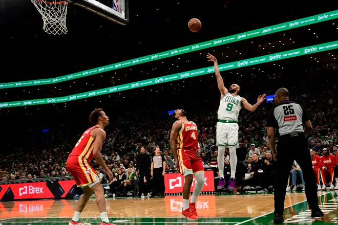 Mar 27, 2026; Boston, Massachusetts, USA; Boston Celtics guard Derrick White (9) shoots over Atlanta Hawks guard Gabe Vincent (4) during the second half at TD Garden. Mandatory Credit: Bob DeChiara-Imagn Images